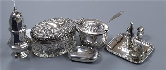 An Edwardian silver chamberstick, a silver caster, a silver mustard pot and three other items